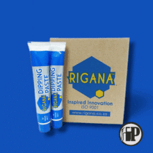 dipping-paste-petromechzw20250721_120600 Two blue and white tubes labeled Dipping Paste stand next to a brown Rigana box with blue and yellow branding and the website www.rigana.co.za, against a blue background.